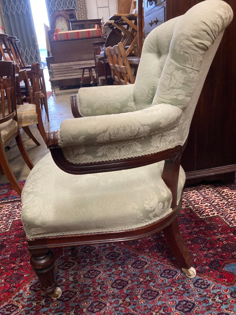 A Victorian carved mahogany upholstered armchair, width 72cm, depth 64cm, height 91cm